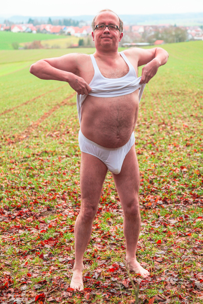 Man strips naked outdoors in Upper Swabia - Undershirt