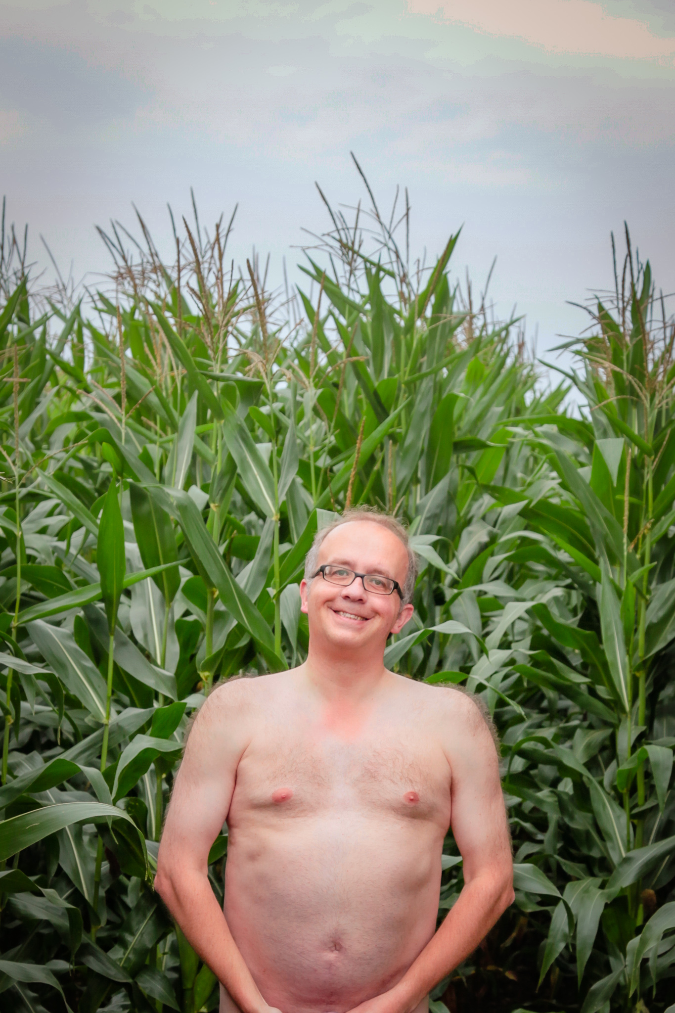 Bare man in cornfield