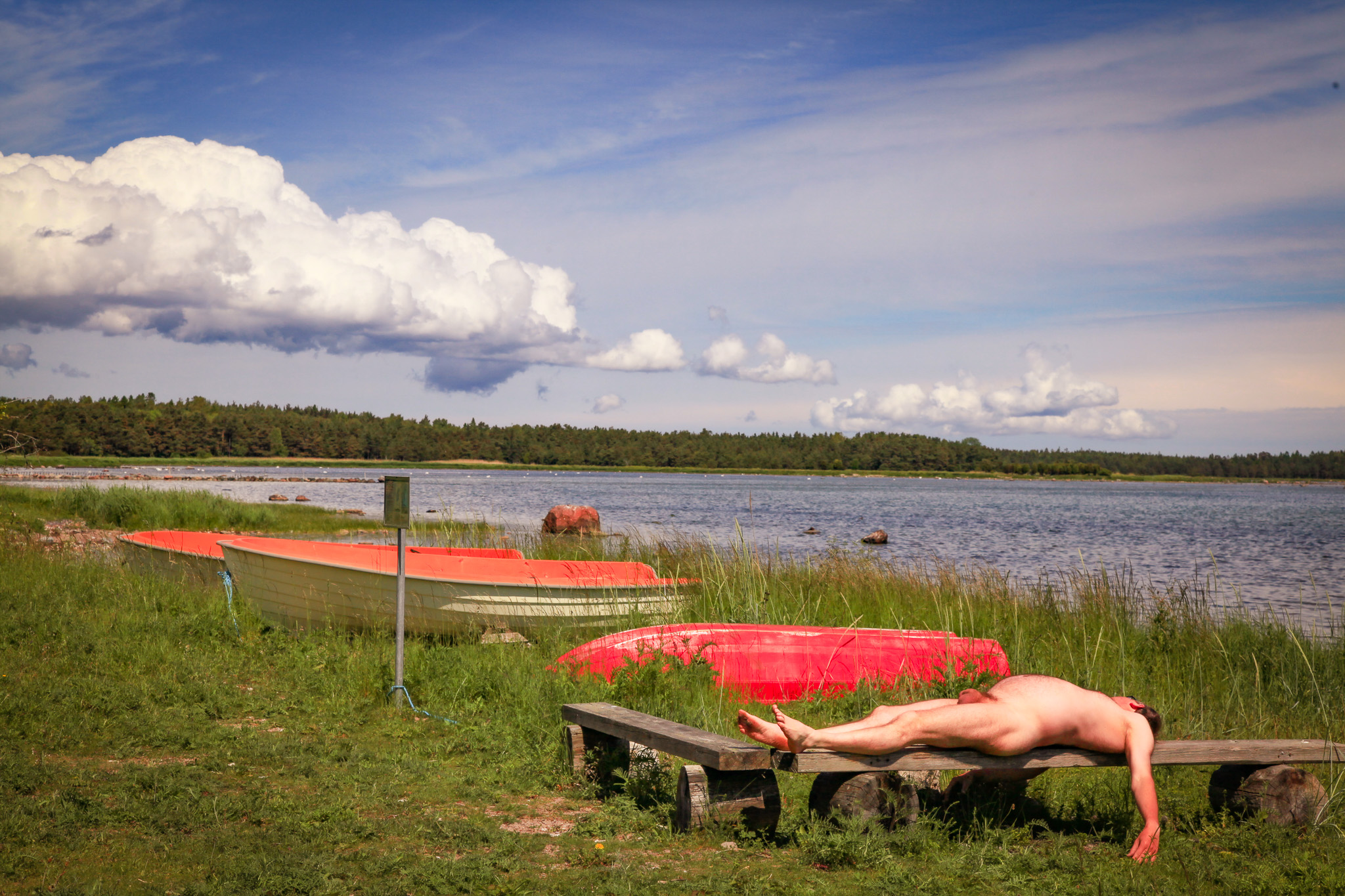 Nude man on Gotland showing his cock and balls when lying on bench