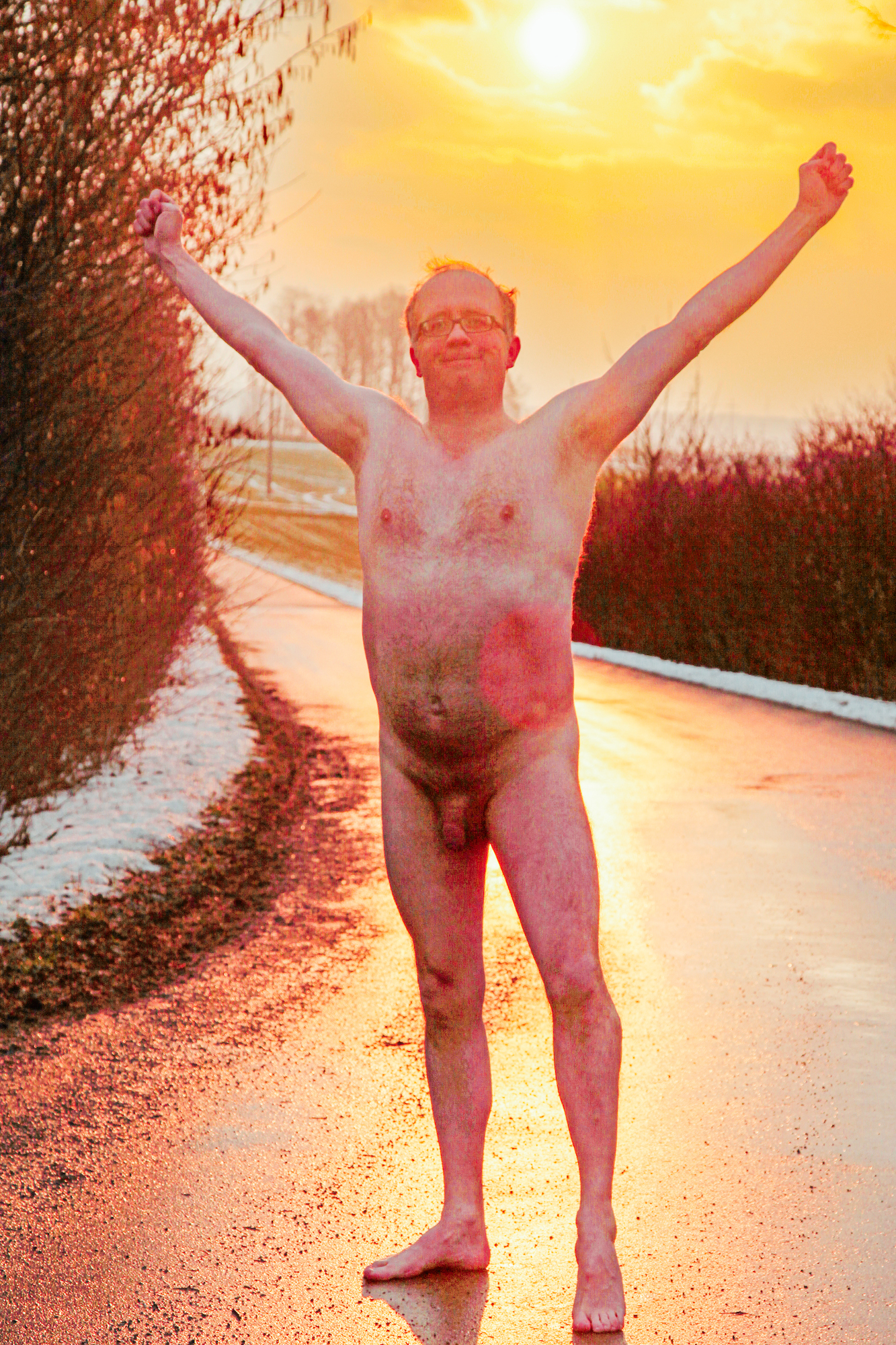 Male nude on an icy road in Mettenberg close to Biberach, Germany