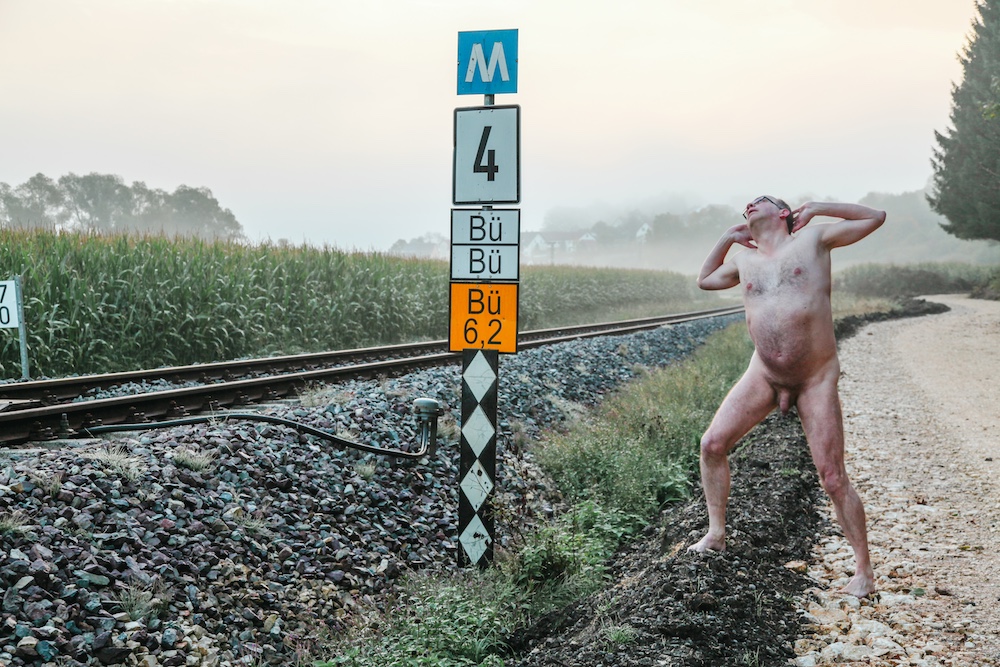 Male nude at railroad track showing his penis
