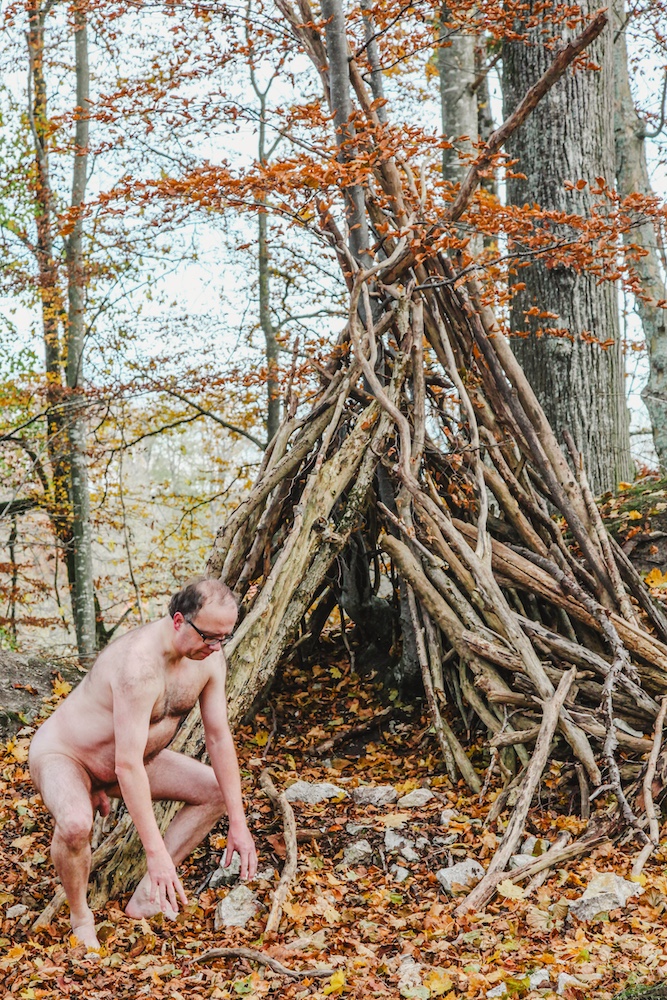 Male nude in the forest exposing his penis