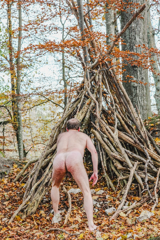 Male nude in the forest exposing his buttocks